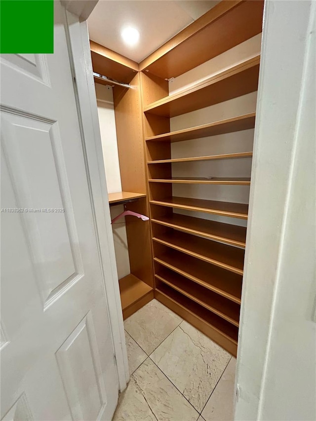 5401 Collins Ave Unit 514, Miami Beach, FL 33140 - walk in closet with light marble finish flooring