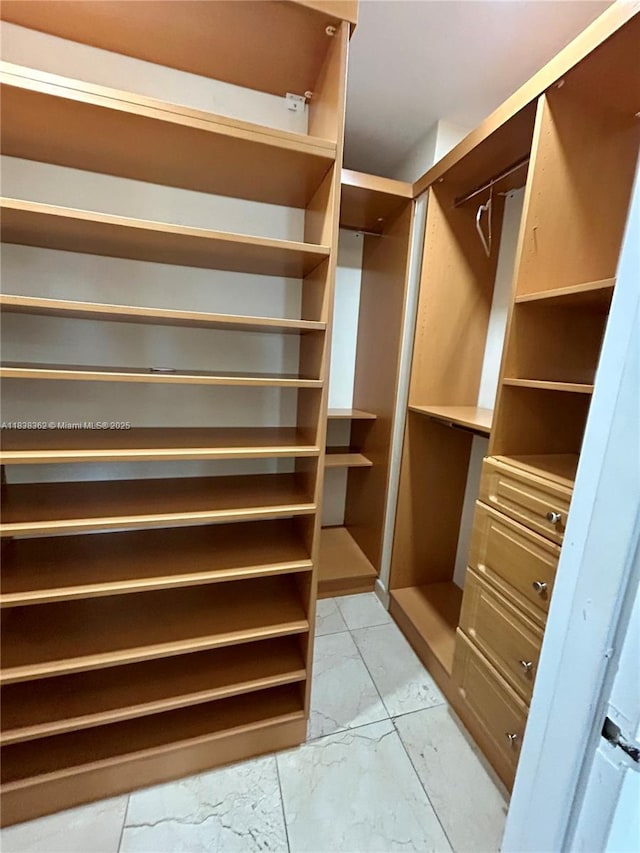 5401 Collins Ave Unit 514, Miami Beach, FL 33140 - walk in closet featuring light marble finish flooring