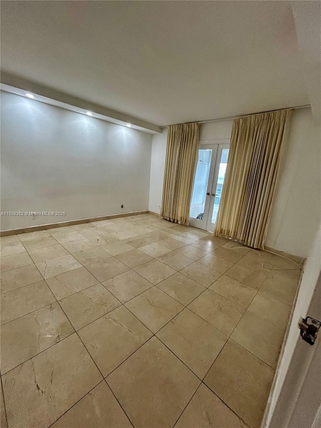5401 Collins Ave Unit 514, Miami Beach, FL 33140 - empty room with french doors and light tile patterned floors