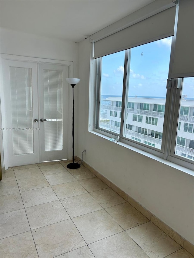5401 Collins Ave Unit 514, Miami Beach, FL 33140 - unfurnished room with plenty of natural light, light tile patterned floors, and french doors