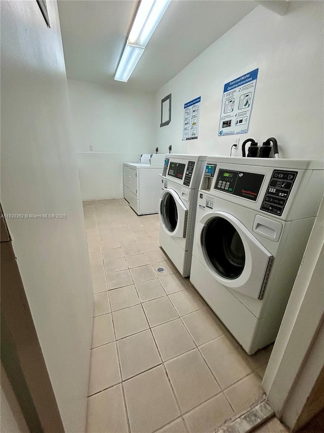 5401 Collins Ave Unit 514, Miami Beach, FL 33140 - shared laundry room featuring washing machine and clothes dryer and light tile patterned floors