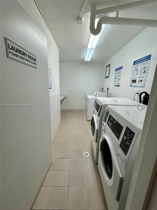 5401 Collins Ave Unit 514, Miami Beach, FL 33140 - community laundry featuring washer and clothes dryer and light tile patterned floors