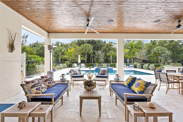 11971 Torreyanna, West Palm Beach, FL 33412 - fenced backyard featuring ceiling fan, an outdoor hangout area, a pool with connected hot tub, view of wooded area, and a patio area
