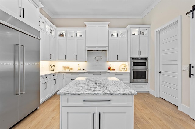 11971 Torreyanna, West Palm Beach, FL 33412 - kitchen featuring stainless steel appliances, ornamental molding, light wood finished floors, white cabinets, and light stone counters