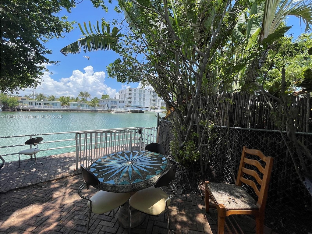 8300 Byron Ave Unit 5, Miami Beach, FL 33141 - view of patio / terrace featuring a water view and outdoor dining area