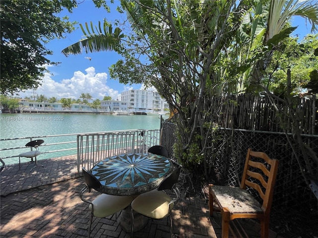 8300 Byron Ave Unit 5, Miami Beach, FL 33141 - view of patio / terrace featuring a water view and outdoor dining area