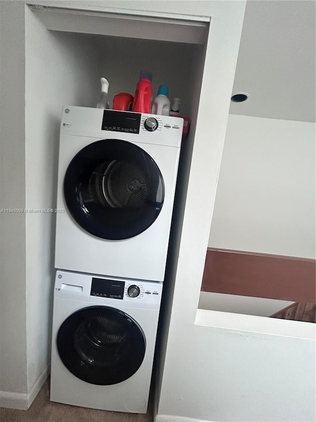 324 Poinciana Dr Unit 906, Sunny Isles Beach, FL 33160 - laundry room featuring stacked washer / drying machine and baseboards