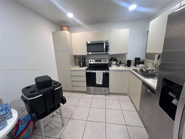 324 Poinciana Dr Unit 906, Sunny Isles Beach, FL 33160 - kitchen featuring stainless steel appliances, light countertops, light tile patterned floors, and recessed lighting