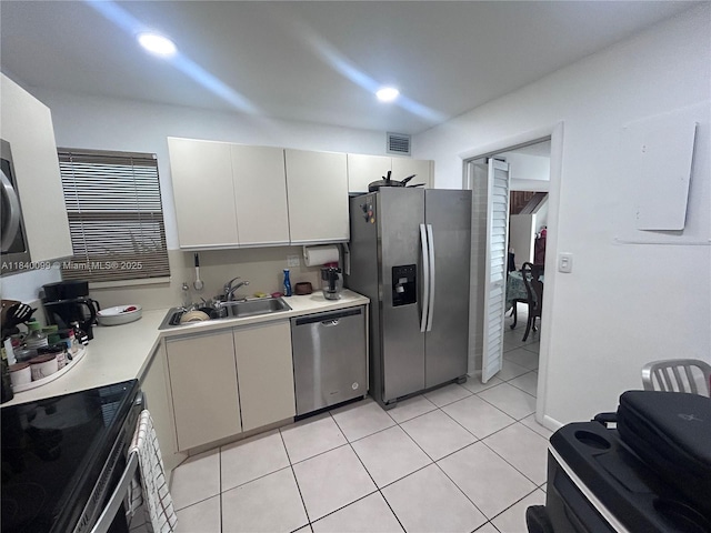 324 Poinciana Dr Unit 906, Sunny Isles Beach, FL 33160 - kitchen featuring stainless steel appliances, light countertops, light tile patterned flooring, white cabinets, and recessed lighting