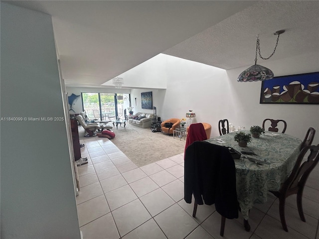 324 Poinciana Dr Unit 906, Sunny Isles Beach, FL 33160 - dining area with light colored carpet, light tile patterned floors, and a textured ceiling