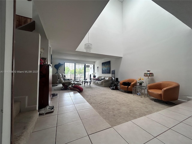 324 Poinciana Dr Unit 906, Sunny Isles Beach, FL 33160 - living room with light colored carpet, light tile patterned floors, and a high ceiling