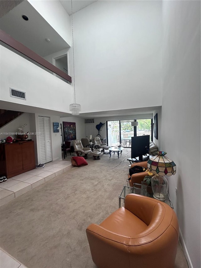 324 Poinciana Dr Unit 906, Sunny Isles Beach, FL 33160 - tiled living area with a towering ceiling and carpet