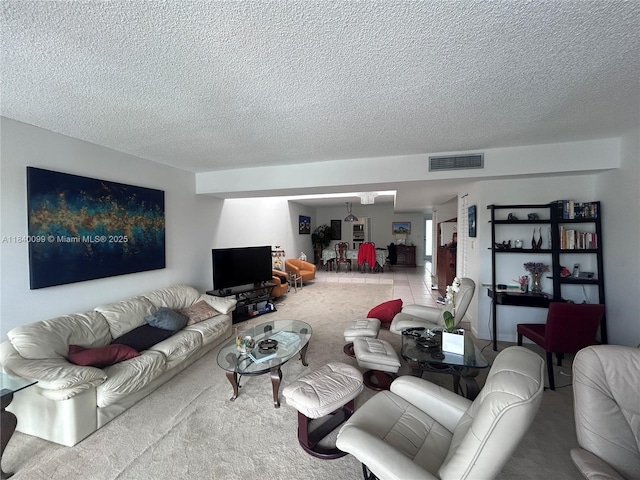 324 Poinciana Dr Unit 906, Sunny Isles Beach, FL 33160 - carpeted living room with a textured ceiling