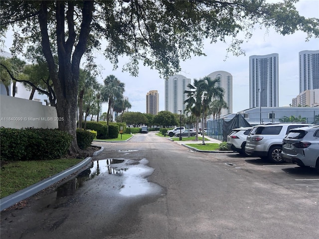 324 Poinciana Dr Unit 906, Sunny Isles Beach, FL 33160 - view of asphalt road with a view of city and curbs
