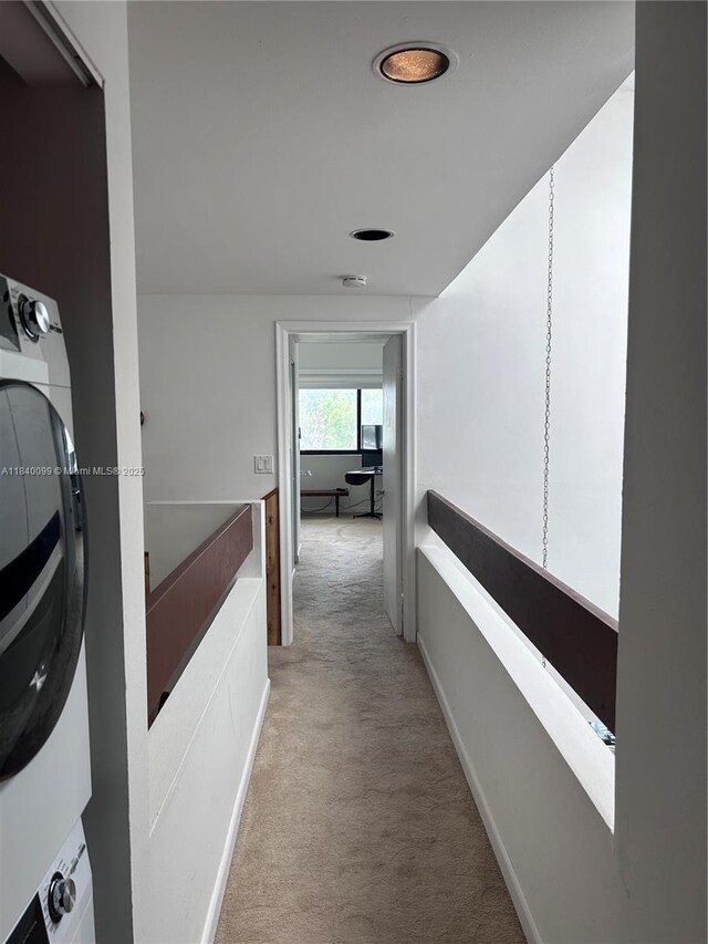 324 Poinciana Dr Unit 906, Sunny Isles Beach, FL 33160 - hall with estacked washer and dryer and light colored carpet