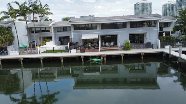 324 Poinciana Dr Unit 906, Sunny Isles Beach, FL 33160 - back of house featuring a water view and stucco siding