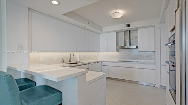 20201 E Country Club Dr Unit 1202, Aventura, FL 33180 - kitchen featuring wall chimney exhaust hood, a peninsula, modern cabinets, a breakfast bar, and black electric stovetop
