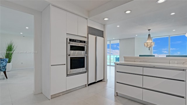 20201 E Country Club Dr Unit 1202, Aventura, FL 33180 - kitchen featuring paneled built in fridge, white cabinets, light countertops, stainless steel double oven, and modern cabinets