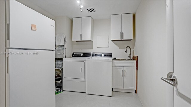 20201 E Country Club Dr Unit 1202, Aventura, FL 33180 - laundry area featuring washer and clothes dryer, cabinet space, and light tile patterned flooring