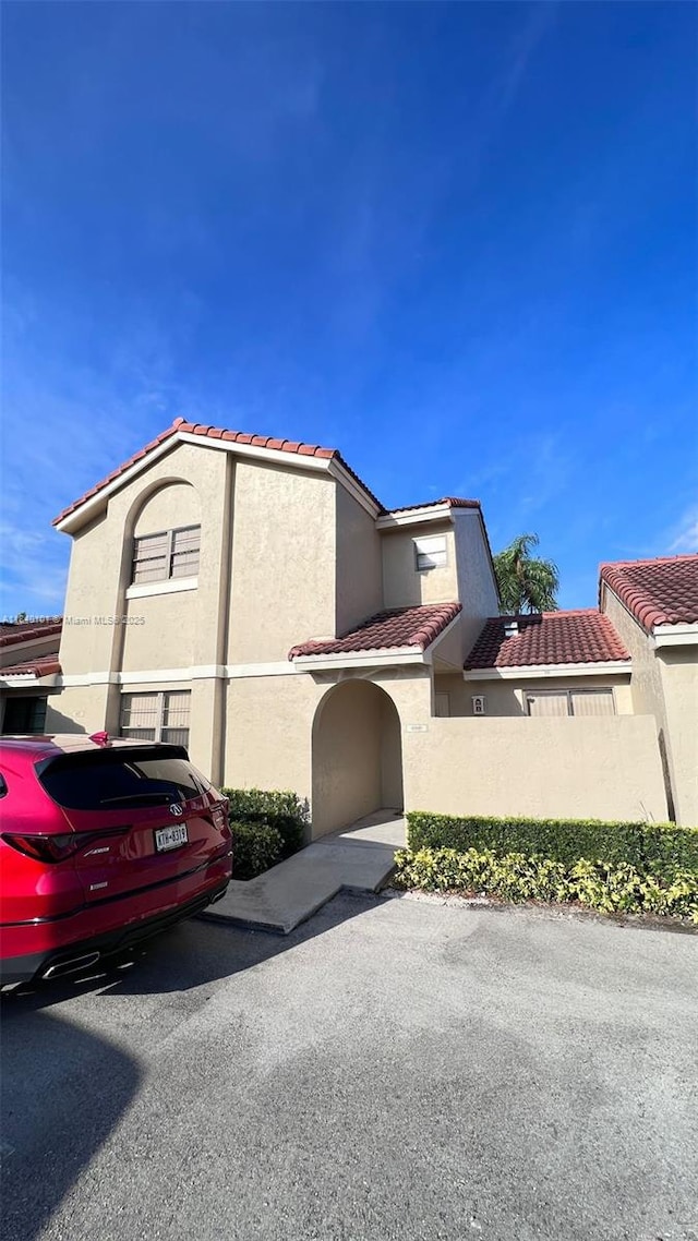 6169 NW 170th Ter, Hialeah, FL 33015 - view of property exterior with a tile roof and stucco siding