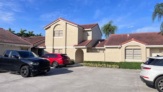 6169 NW 170th Ter, Hialeah, FL 33015 - mediterranean / spanish house featuring stucco siding, a tiled roof, and uncovered parking