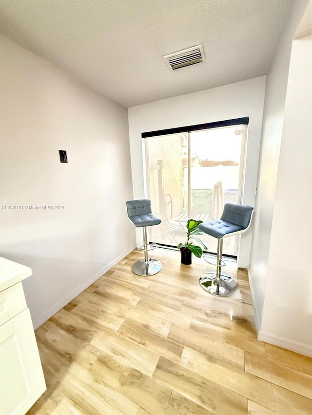 6169 NW 170th Ter, Hialeah, FL 33015 - sitting room with light wood finished floors and a textured ceiling