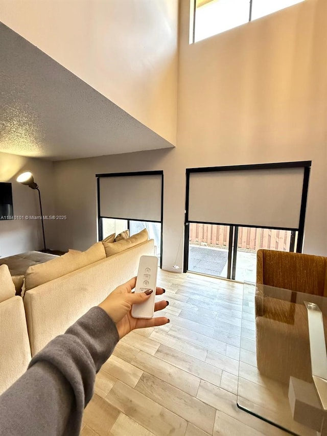 6169 NW 170th Ter, Hialeah, FL 33015 - home theater room with wood finished floors and a towering ceiling