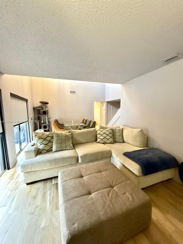 6169 NW 170th Ter, Hialeah, FL 33015 - living room featuring wood finished floors and a textured ceiling