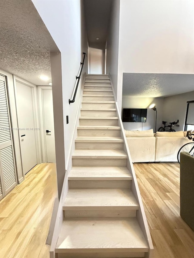 6169 NW 170th Ter, Hialeah, FL 33015 - stairs with wood finished floors and a textured ceiling