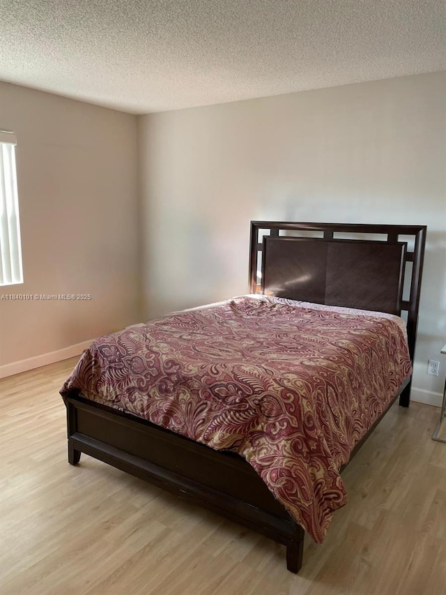 6169 NW 170th Ter, Hialeah, FL 33015 - bedroom with wood finished floors and a textured ceiling