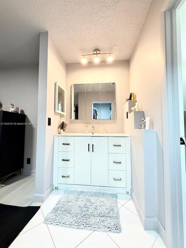 6169 NW 170th Ter, Hialeah, FL 33015 - bathroom with vanity, tile patterned flooring, and a textured ceiling