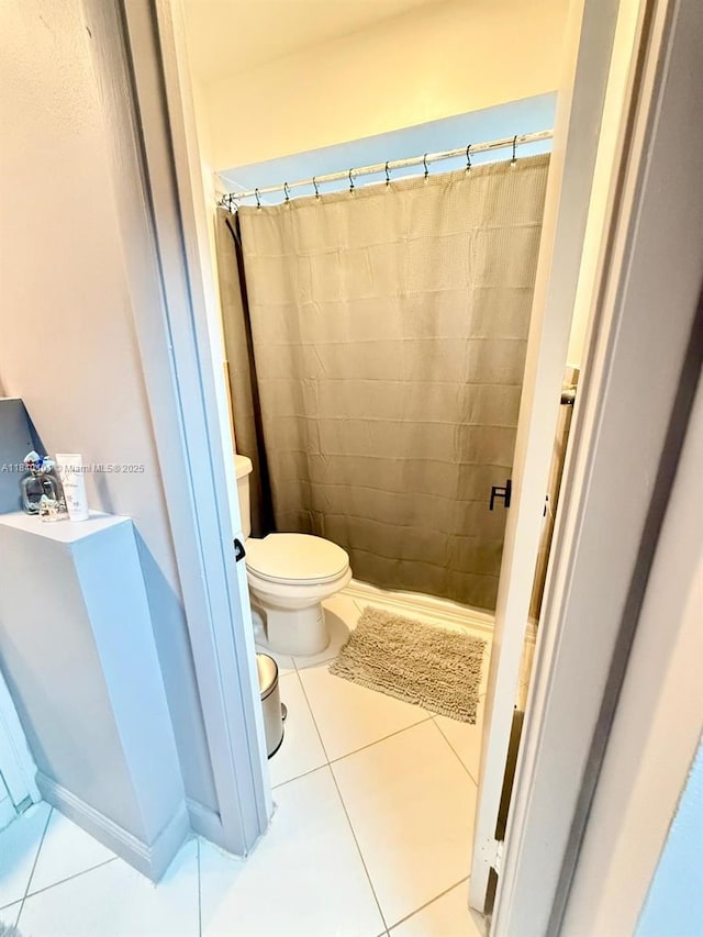 6169 NW 170th Ter, Hialeah, FL 33015 - bathroom featuring tile patterned flooring and curtained shower