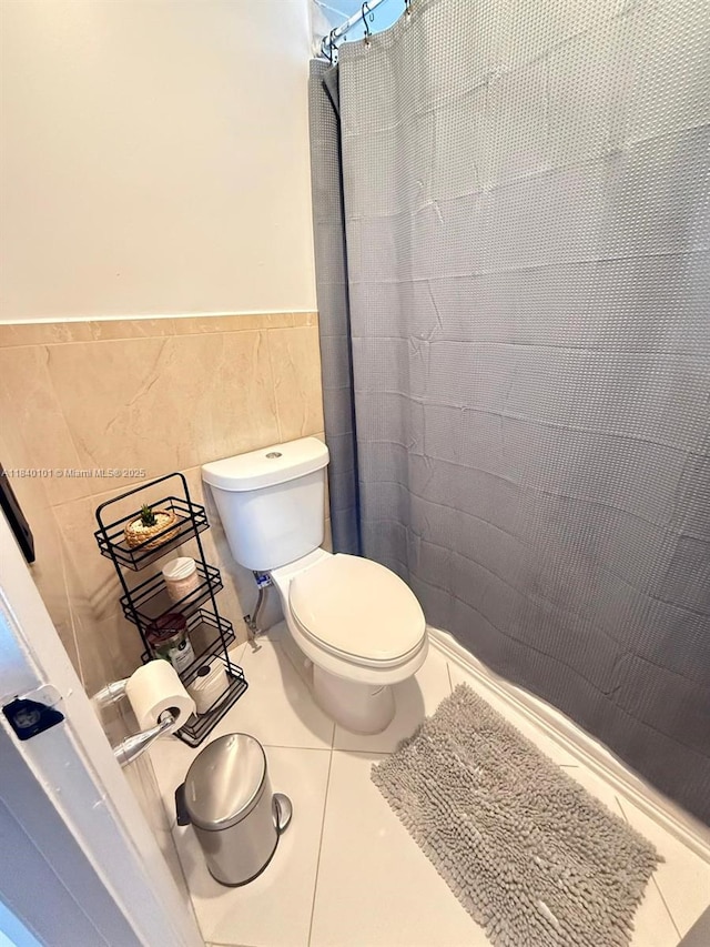 6169 NW 170th Ter, Hialeah, FL 33015 - bathroom featuring tile walls, tile patterned flooring, wainscoting, and a shower with curtain