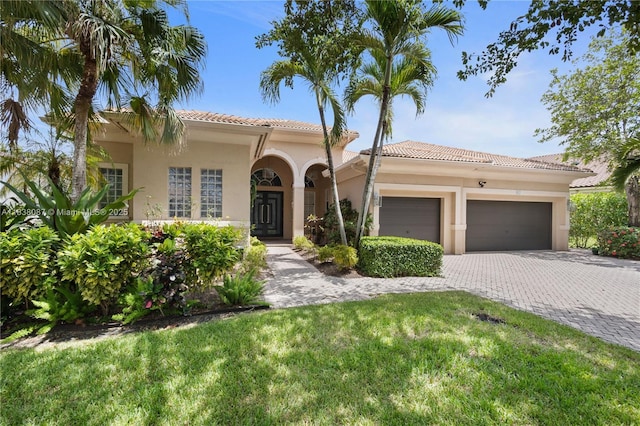 932 NW 123rd Dr, Coral Springs, FL 33071 - mediterranean / spanish home with a garage, stucco siding, a tile roof, and decorative driveway