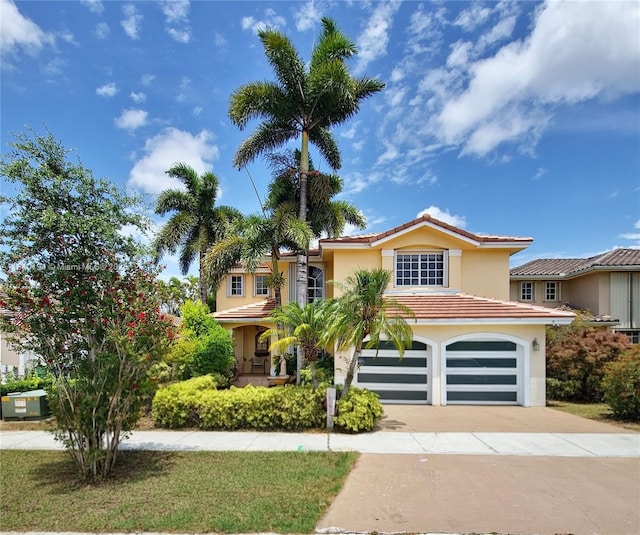 9057 SW 157th Path, Miami, FL 33196 - mediterranean / spanish house with an attached garage, stucco siding, driveway, and a tile roof