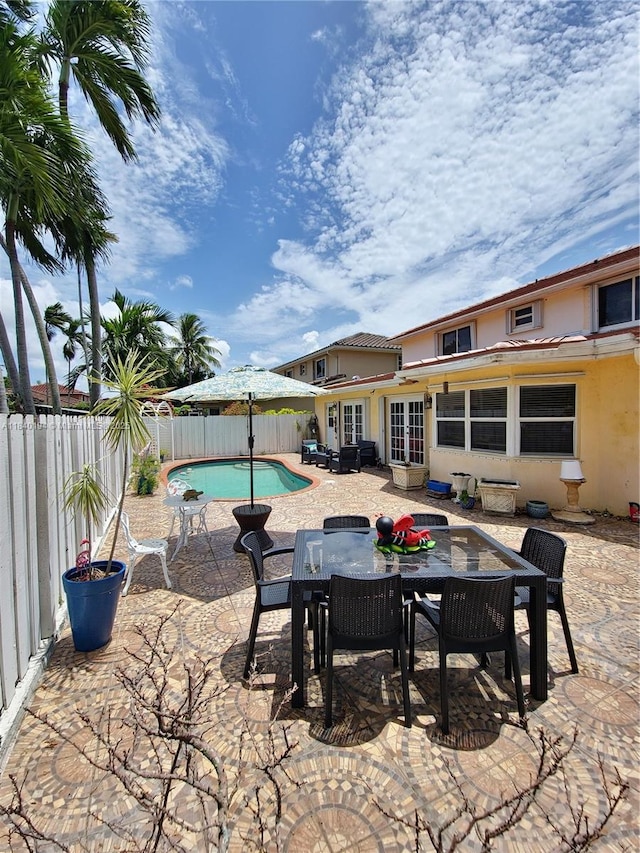9057 SW 157th Path, Miami, FL 33196 - fenced backyard featuring a patio, french doors, and outdoor dining area