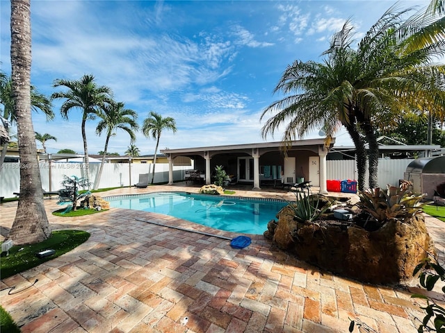180 E 46th St, Hialeah, FL 33013 - view of swimming pool featuring a patio area and a fenced backyard
