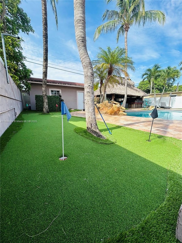 180 E 46th St, Hialeah, FL 33013 - fenced yard with an area to practice putting