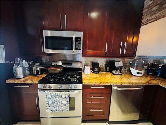 180 E 46th St, Hialeah, FL 33013 - kitchen featuring appliances with stainless steel finishes, backsplash, light stone countertops, and dark brown cabinets