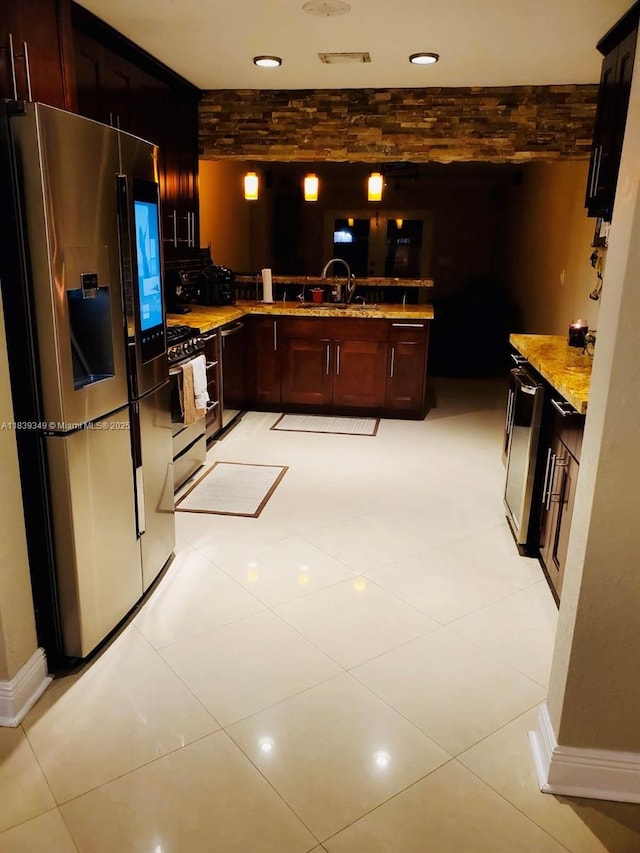 180 E 46th St, Hialeah, FL 33013 - kitchen with appliances with stainless steel finishes, a peninsula, and light stone countertops