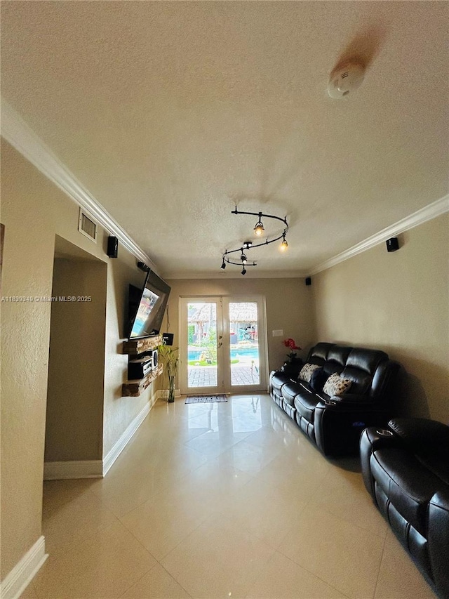 180 E 46th St, Hialeah, FL 33013 - living room featuring french doors, a textured ceiling, ornamental molding, and rail lighting