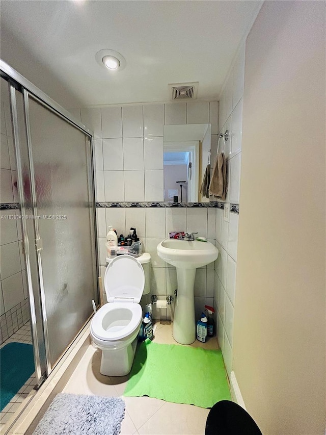 180 E 46th St, Hialeah, FL 33013 - full bathroom with a shower stall, tile patterned floors, and tile walls