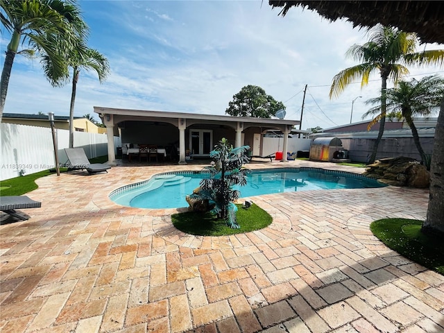 180 E 46th St, Hialeah, FL 33013 - view of swimming pool featuring french doors, a patio area, and a fenced backyard