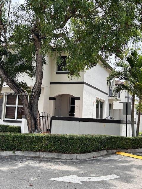 8625 SW 152nd Ave Unit 250, Miami, FL 33193 - view of building exterior with a fenced front yard and uncovered parking