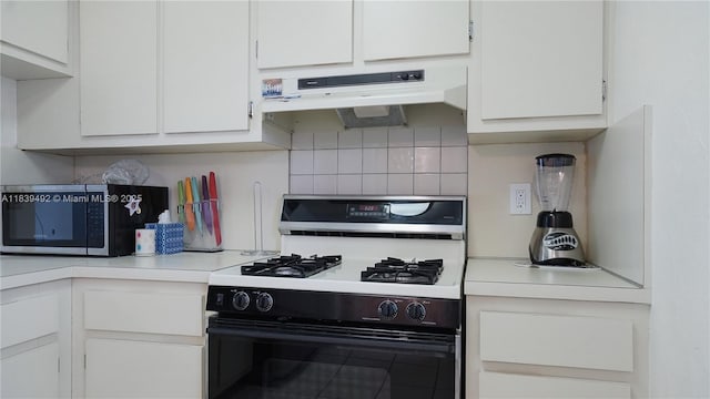 1033 Lenox Ave Unit 304, Miami Beach, FL 33139 - kitchen with range with gas cooktop, exhaust hood, white cabinetry, light countertops, and stainless steel microwave