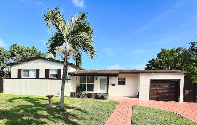 9130 SW 17th Ter, Miami, FL 33165 - view of front of home with an attached garage, stucco siding, and driveway