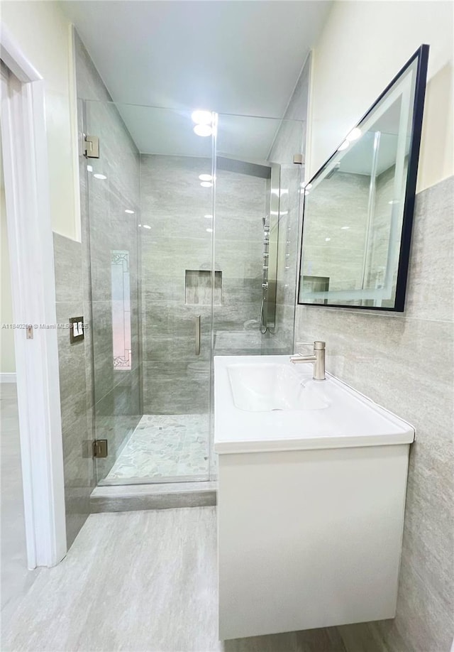 9130 SW 17th Ter, Miami, FL 33165 - bathroom featuring vanity, tile walls, a shower stall, and wood finished floors