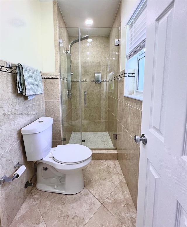 9130 SW 17th Ter, Miami, FL 33165 - bathroom with tile walls, a stall shower, and tile patterned floors
