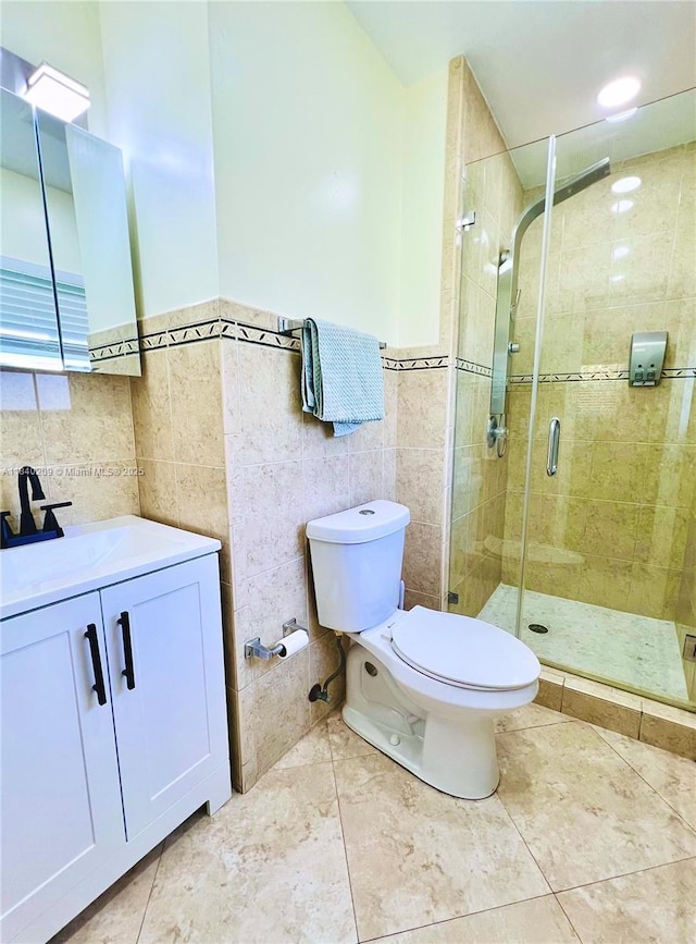 9130 SW 17th Ter, Miami, FL 33165 - bathroom featuring tile walls, vanity, a shower stall, a wainscoted wall, and tile patterned flooring
