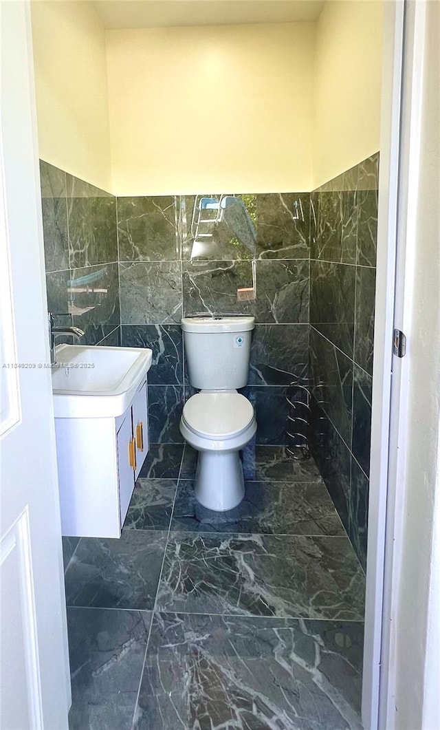 9130 SW 17th Ter, Miami, FL 33165 - bathroom featuring vanity, wainscoting, marble finish flooring, and tile walls